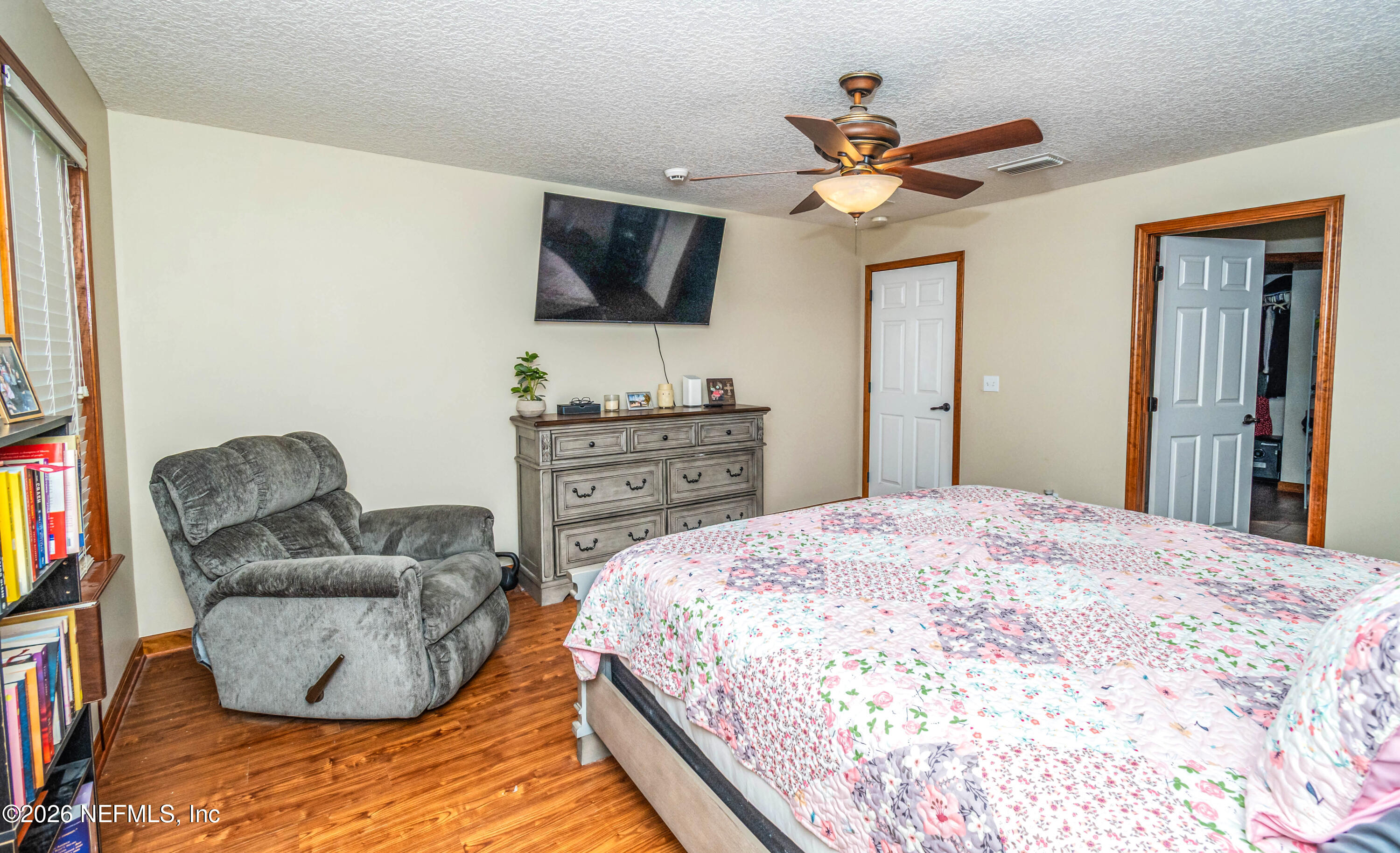 7667 Odis Yarborough Road Glen St. Mary, FL 32040 - Photo 23 of 40 a bedroom with a bed and a flat screen tv