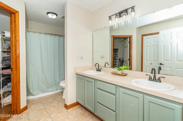 a bathroom with a double vanity sink and a mirror