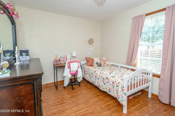 a bedroom with a bed and a table in it