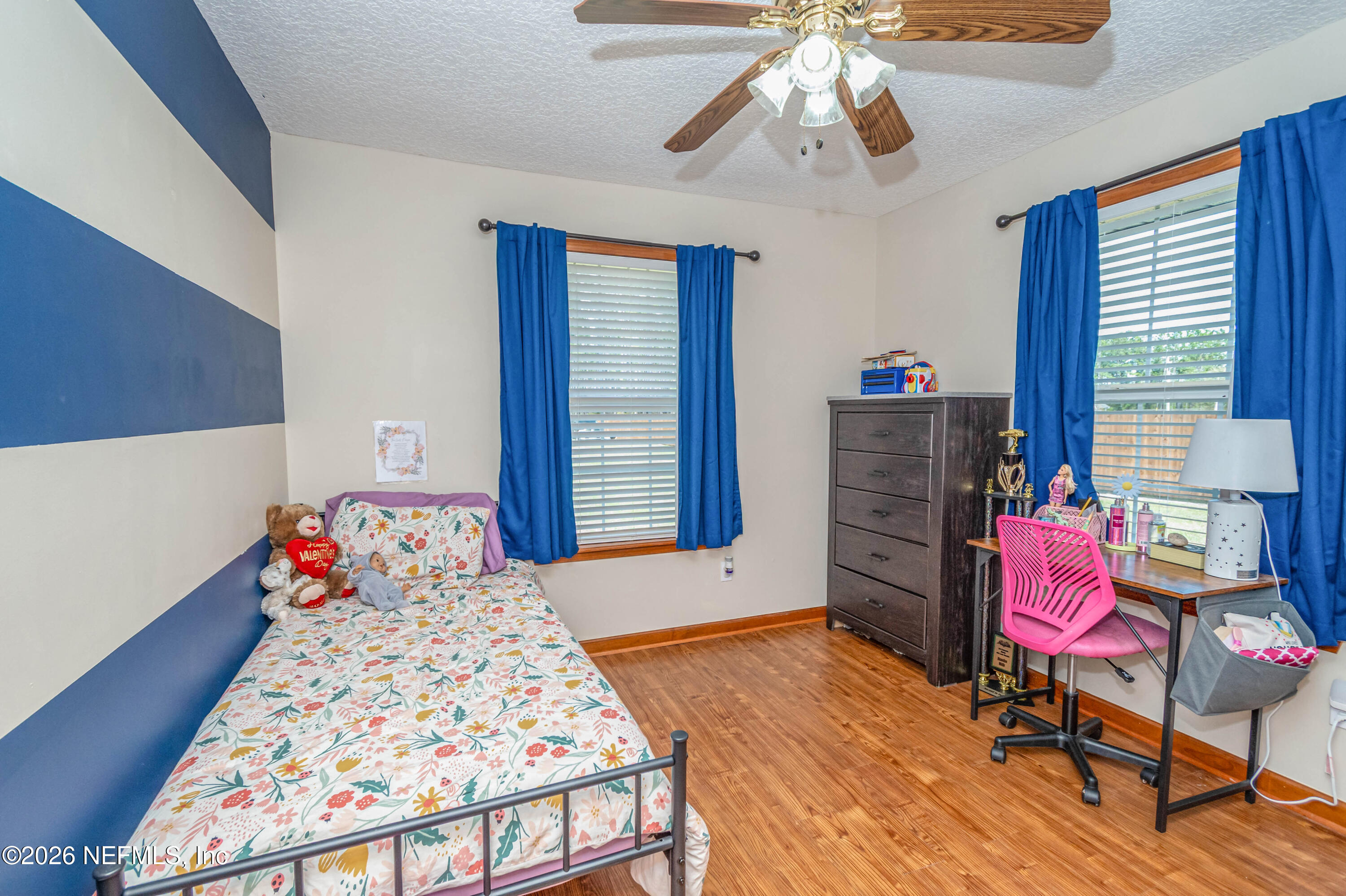 7667 Odis Yarborough Road Glen St. Mary, FL 32040 - Photo 28 of 40 a bedroom with a bed and wooden floor