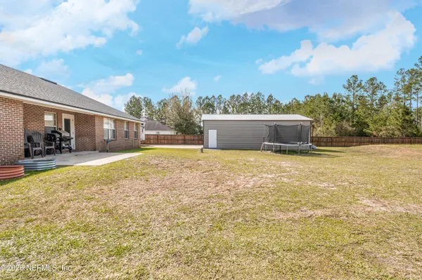 a swimming pool with trees in front of it