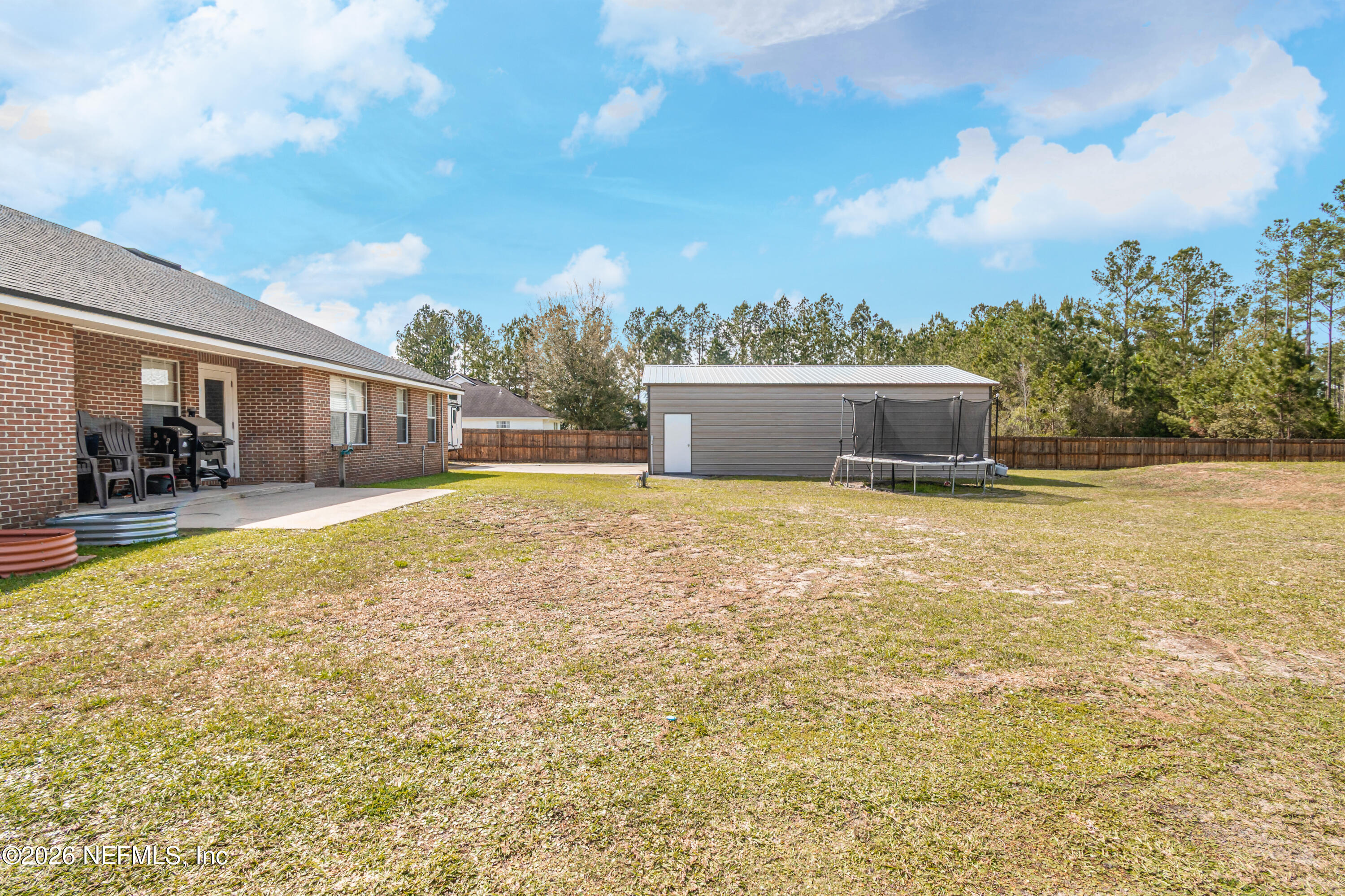 7667 Odis Yarborough Road Glen St. Mary, FL 32040 - Photo 30 of 40 a swimming pool with trees in front of it