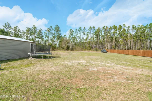a view of outdoor space with deck and yard