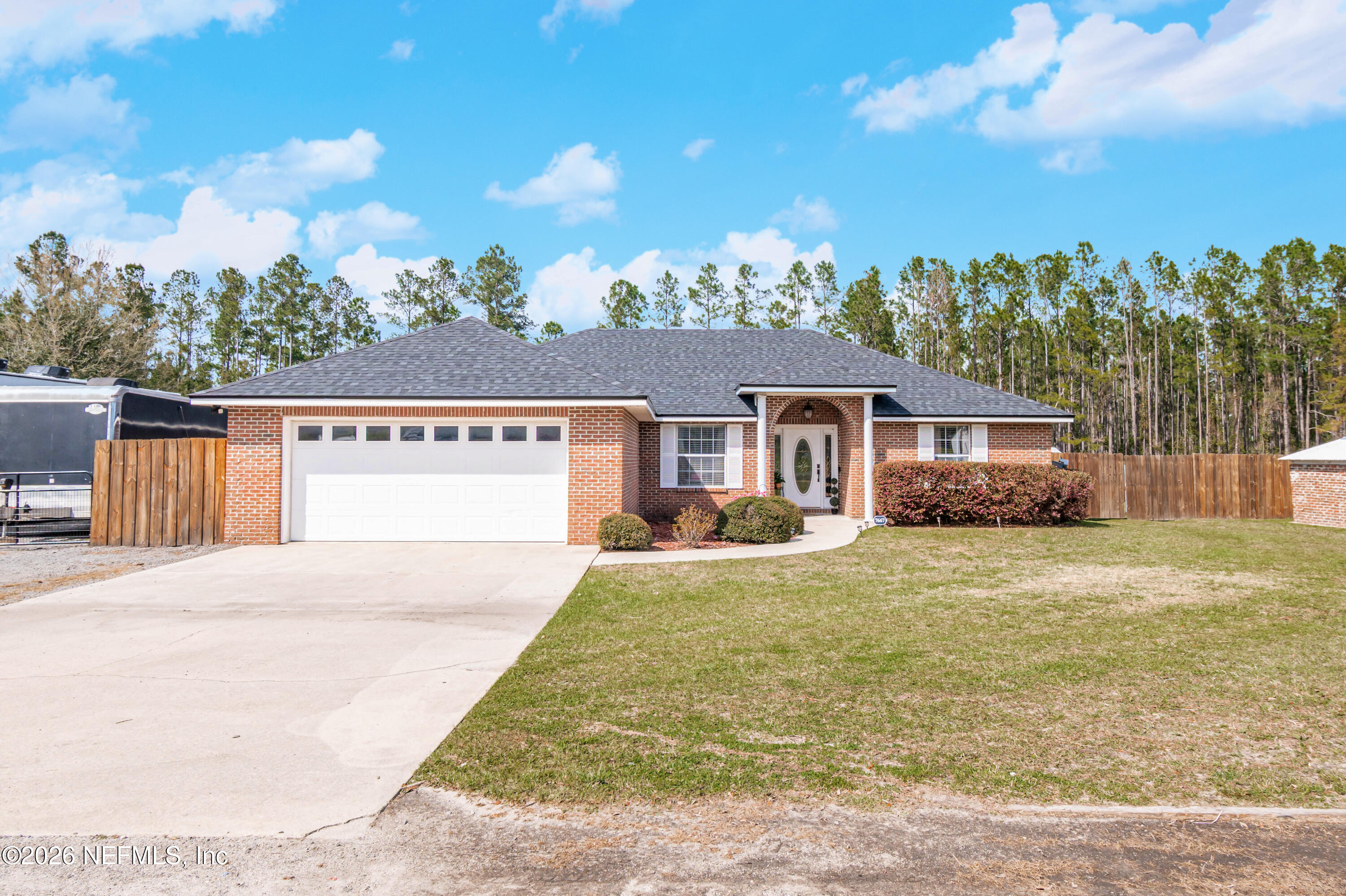 7667 Odis Yarborough Road Glen St. Mary, FL 32040 - Photo 8 of 40 a view of a house with a backyard and a tree