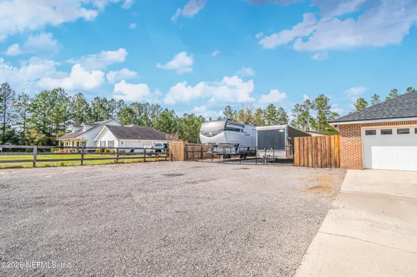 a view of a house with swimming pool and sitting area