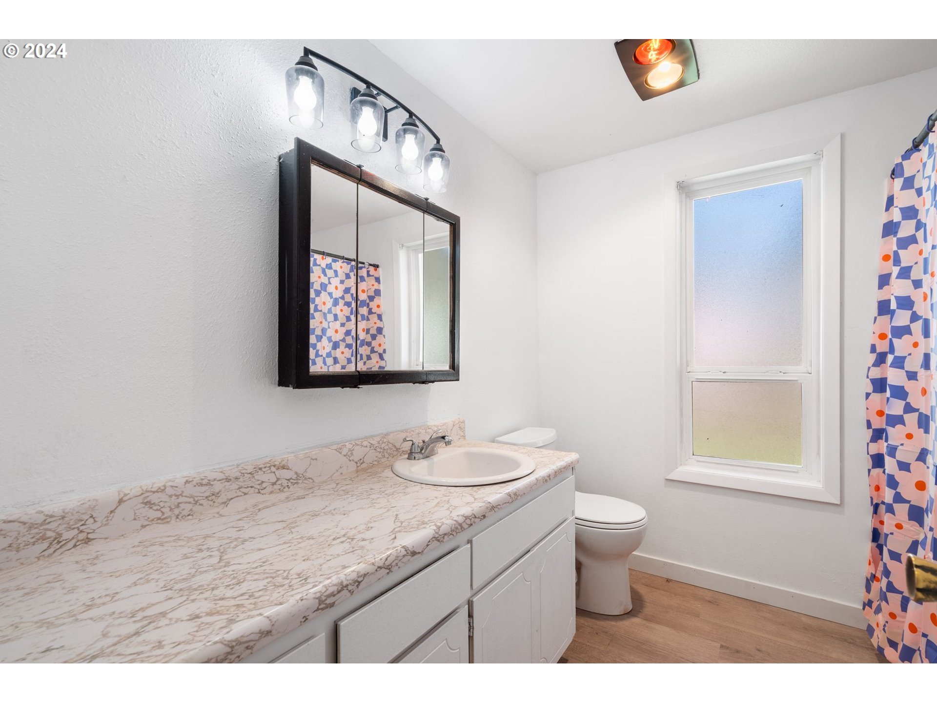 10038 South New Era Road, Unit 98 Canby, OR 97013 - Photo 17 of 34 a bathroom with a granite countertop sink mirror vanity and toilet