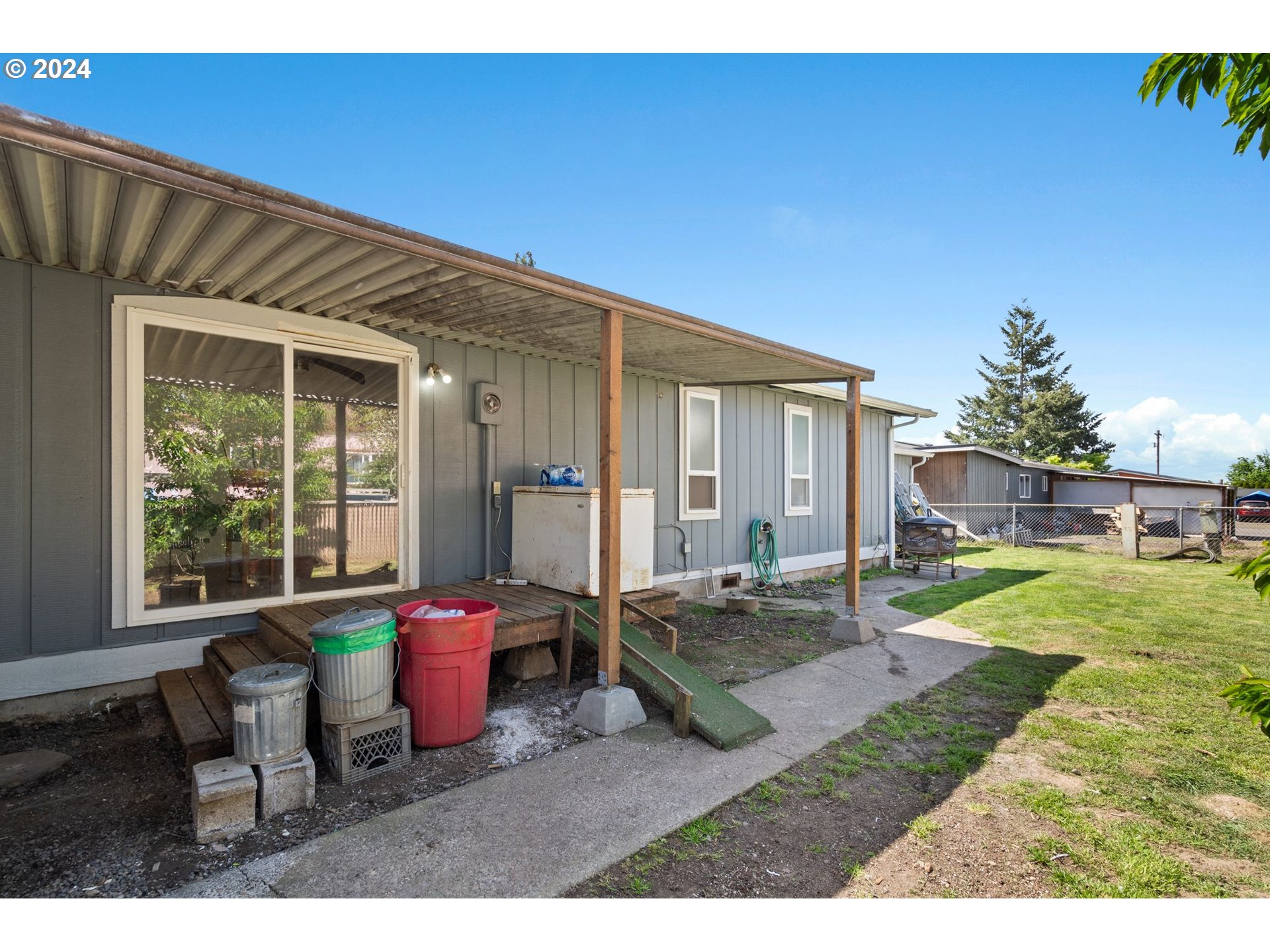 10038 South New Era Road, Unit 98 Canby, OR 97013 - Photo 26 of 34 a view of a house with backyard porch and sitting area