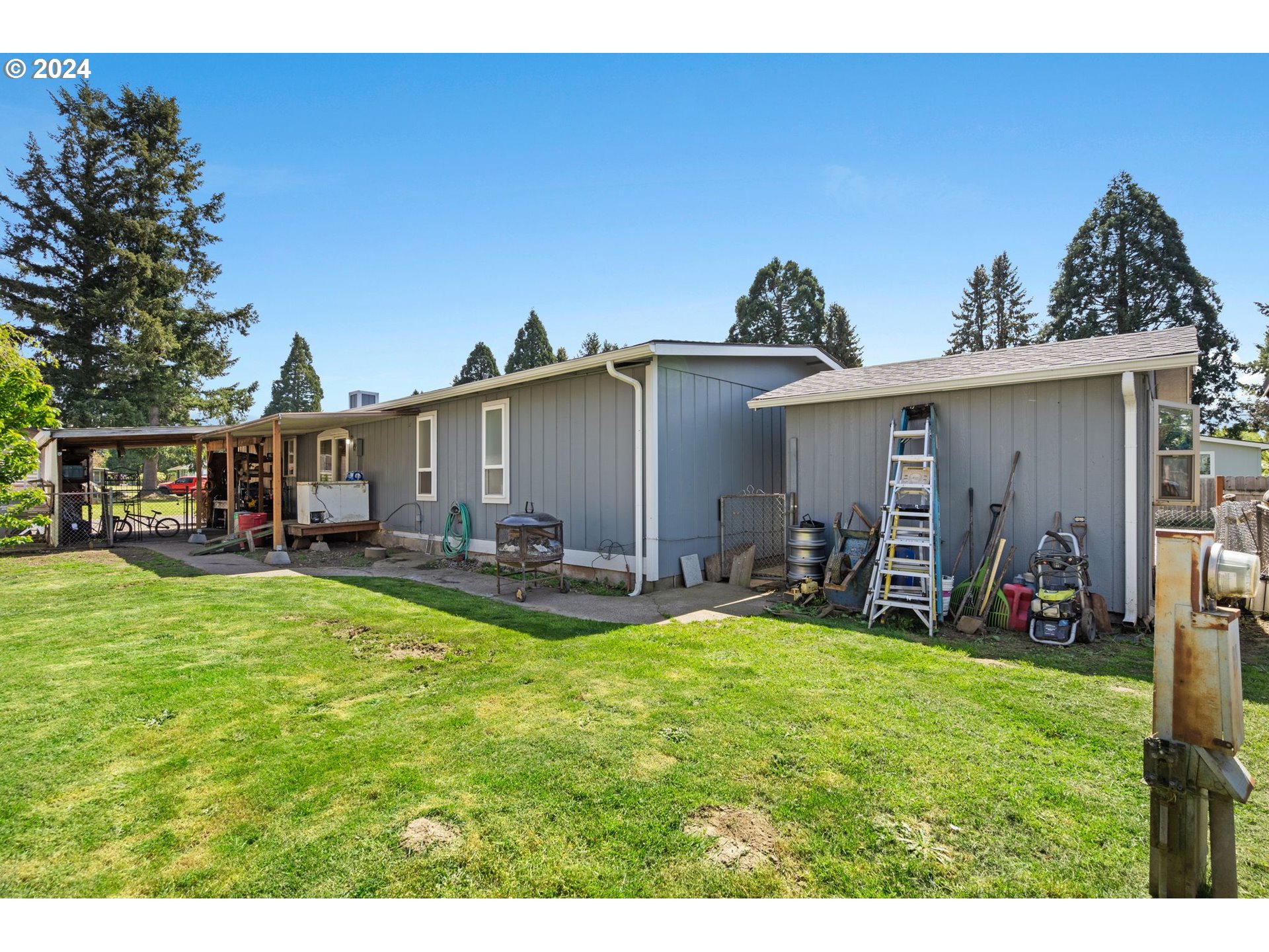 10038 South New Era Road, Unit 98 Canby, OR 97013 - Photo 27 of 34 a view of a house with backyard porch and sitting area