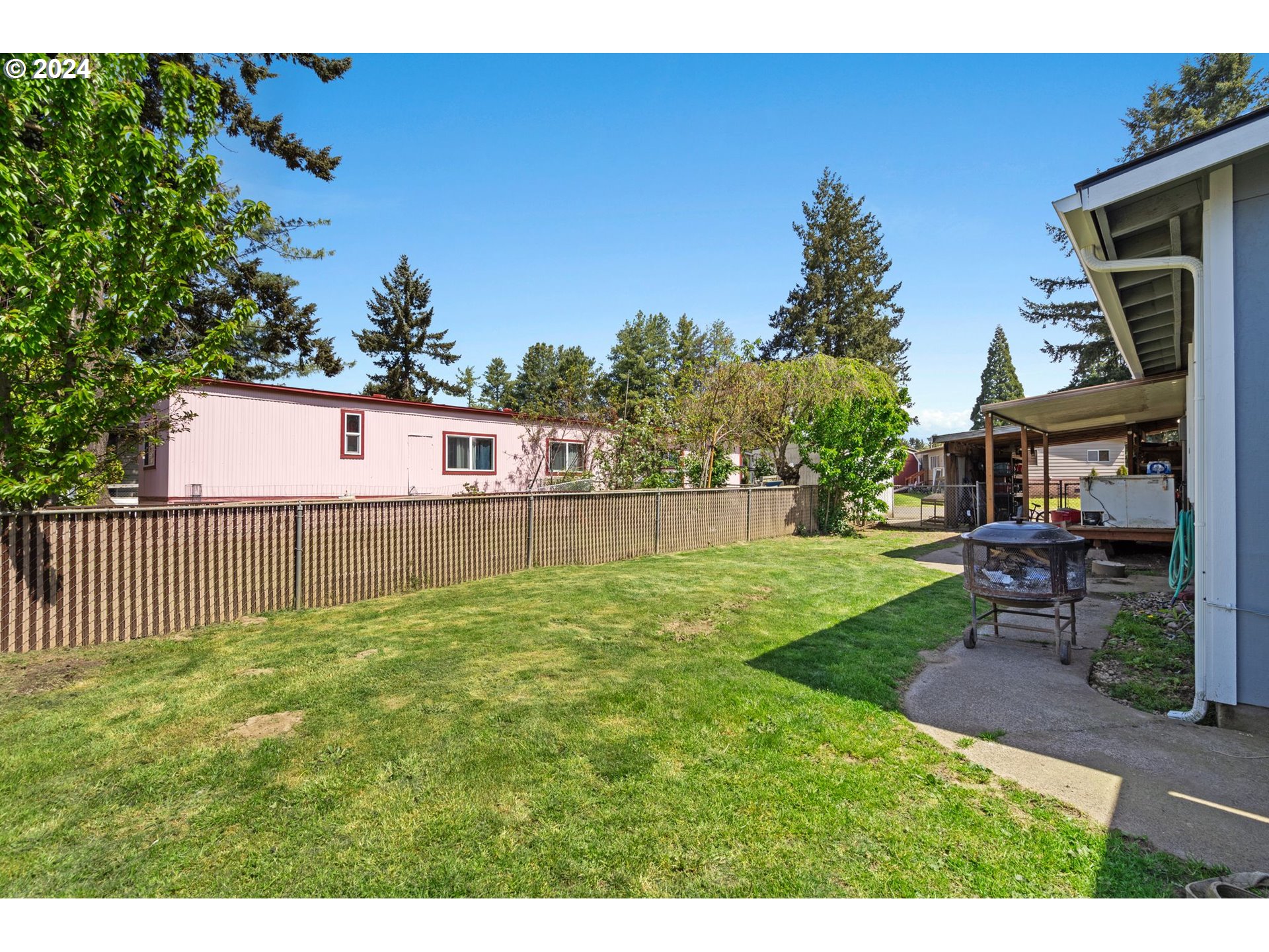 10038 South New Era Road, Unit 98 Canby, OR 97013 - Photo 28 of 34 a view of a backyard with a garden