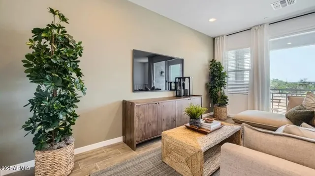 a living room with furniture and a large window