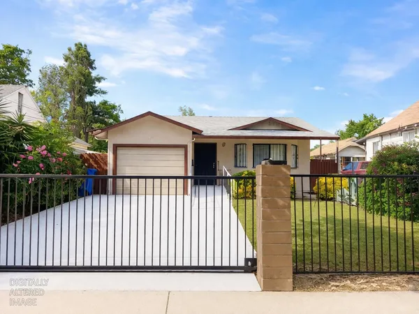 a front view of a house with a garden