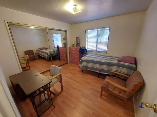 a bedroom with furniture and a window