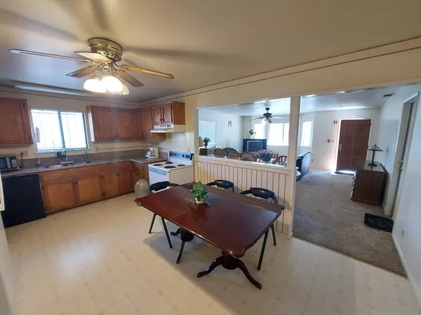 a kitchen with a table chairs and a refrigerator