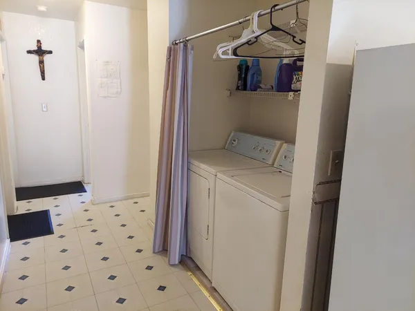 a view of a hallway with washer and dryer