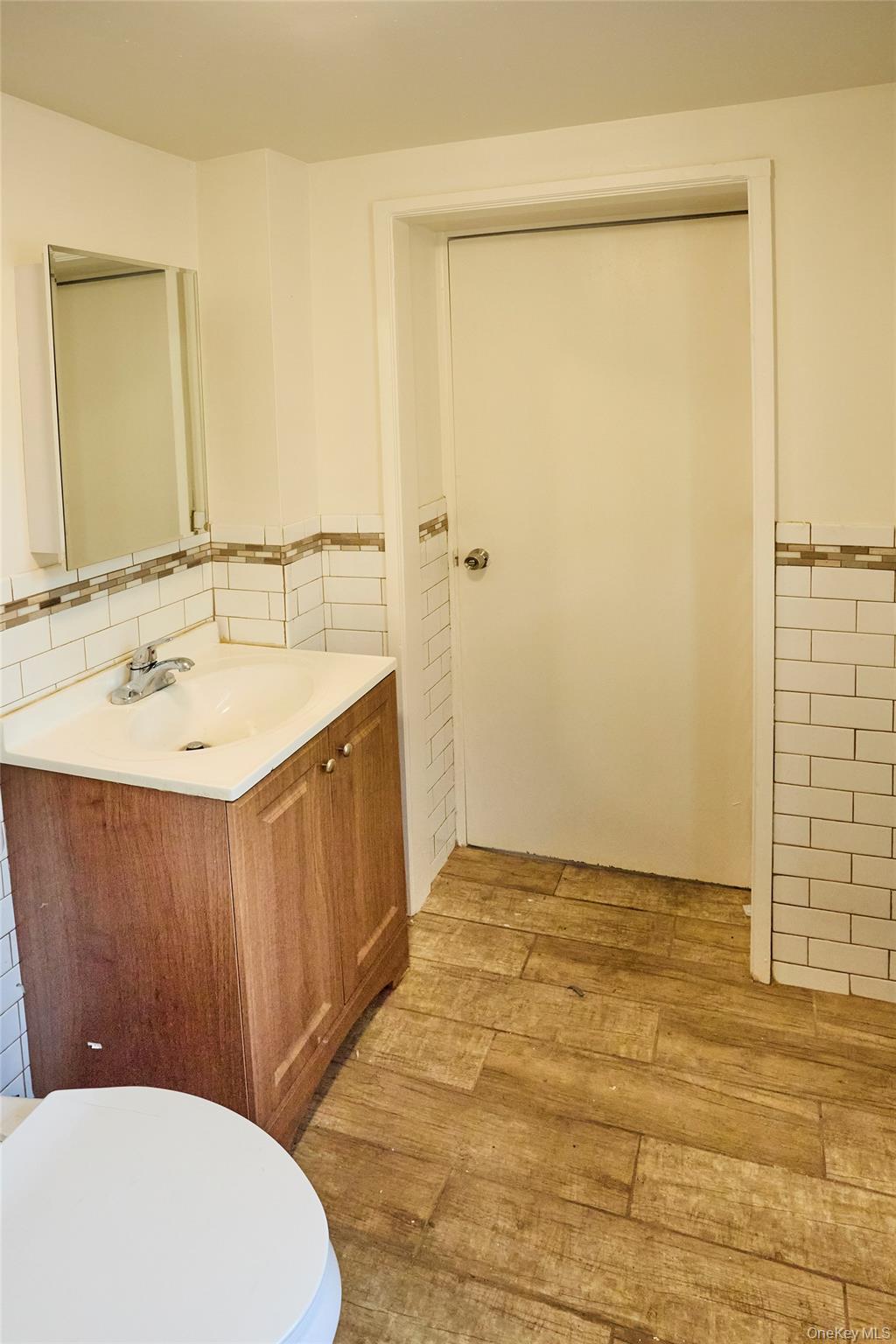 457 Main Street, Unit 3 Beacon, NY 12508 - Photo 11 of 13 a bathroom with a sink a toilet a mirror and shower