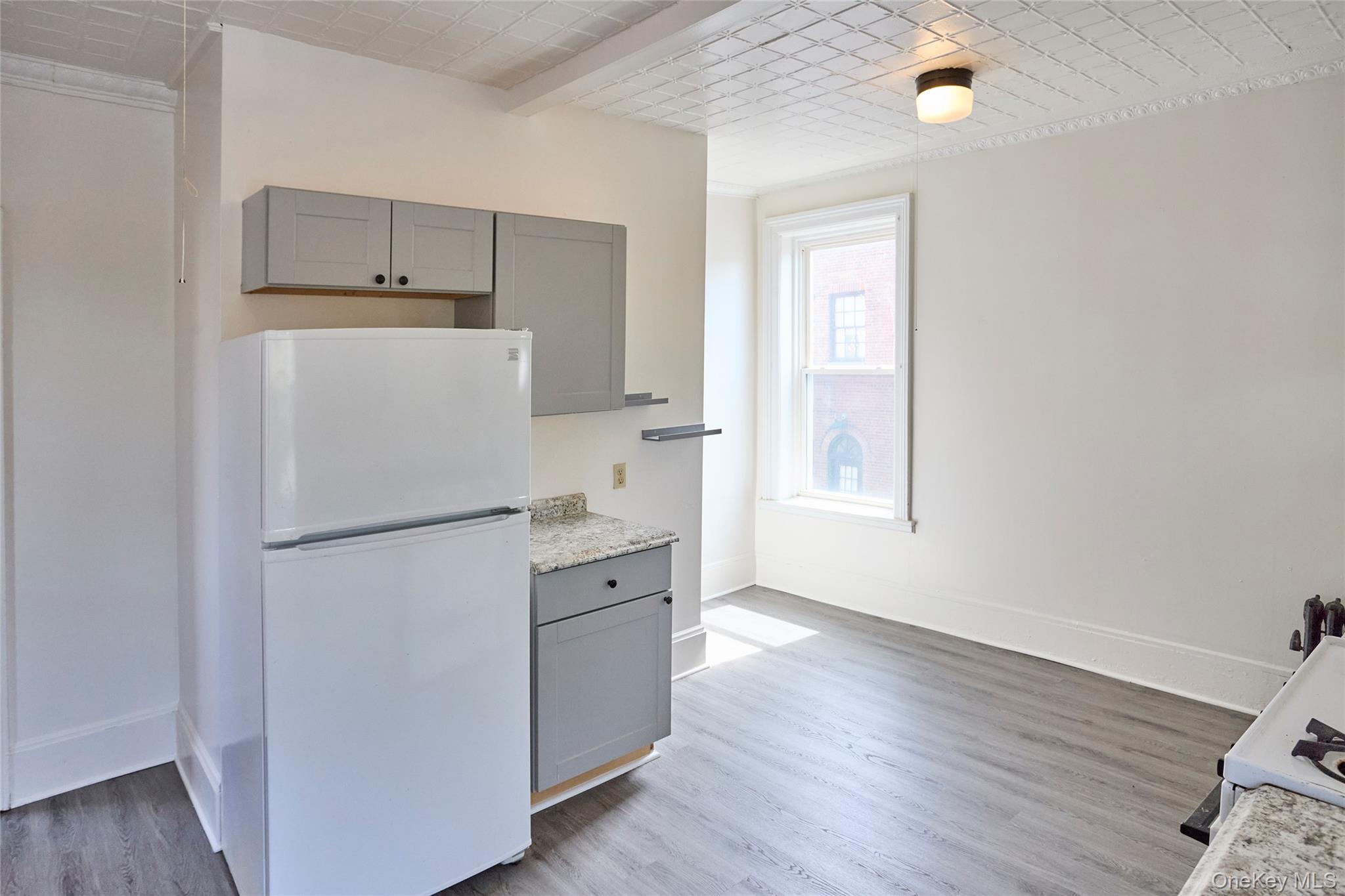 457 Main Street, Unit 3 Beacon, NY 12508 - Photo 12 of 13 a white refrigerator freezer sitting inside of a kitchen