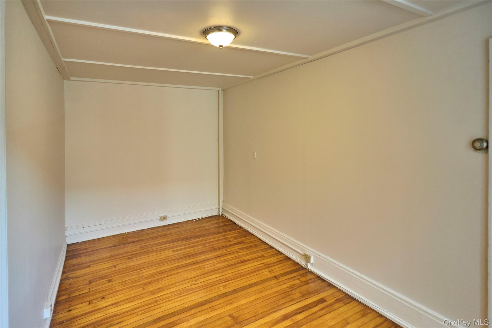 457 Main Street, Unit 3 Beacon, NY 12508 - Photo 9 of 13 a view of an empty room with wooden floor