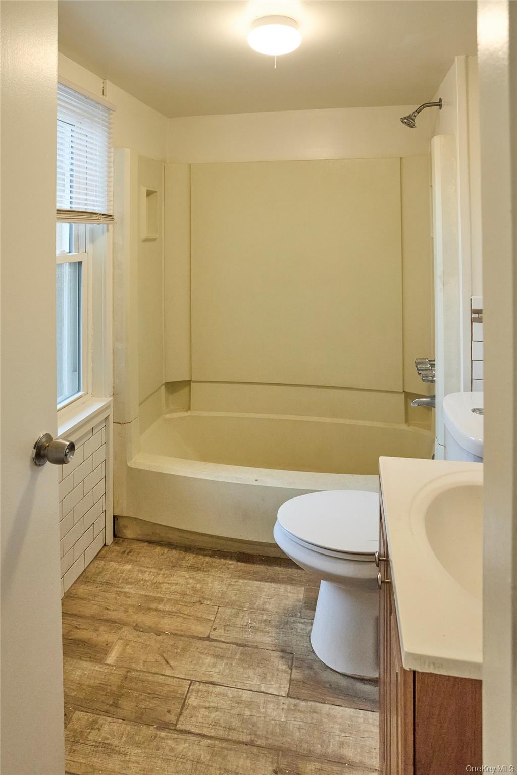 457 Main Street, Unit 3 Beacon, NY 12508 - Photo 10 of 13 a bathroom with a toilet a sink and bathtub