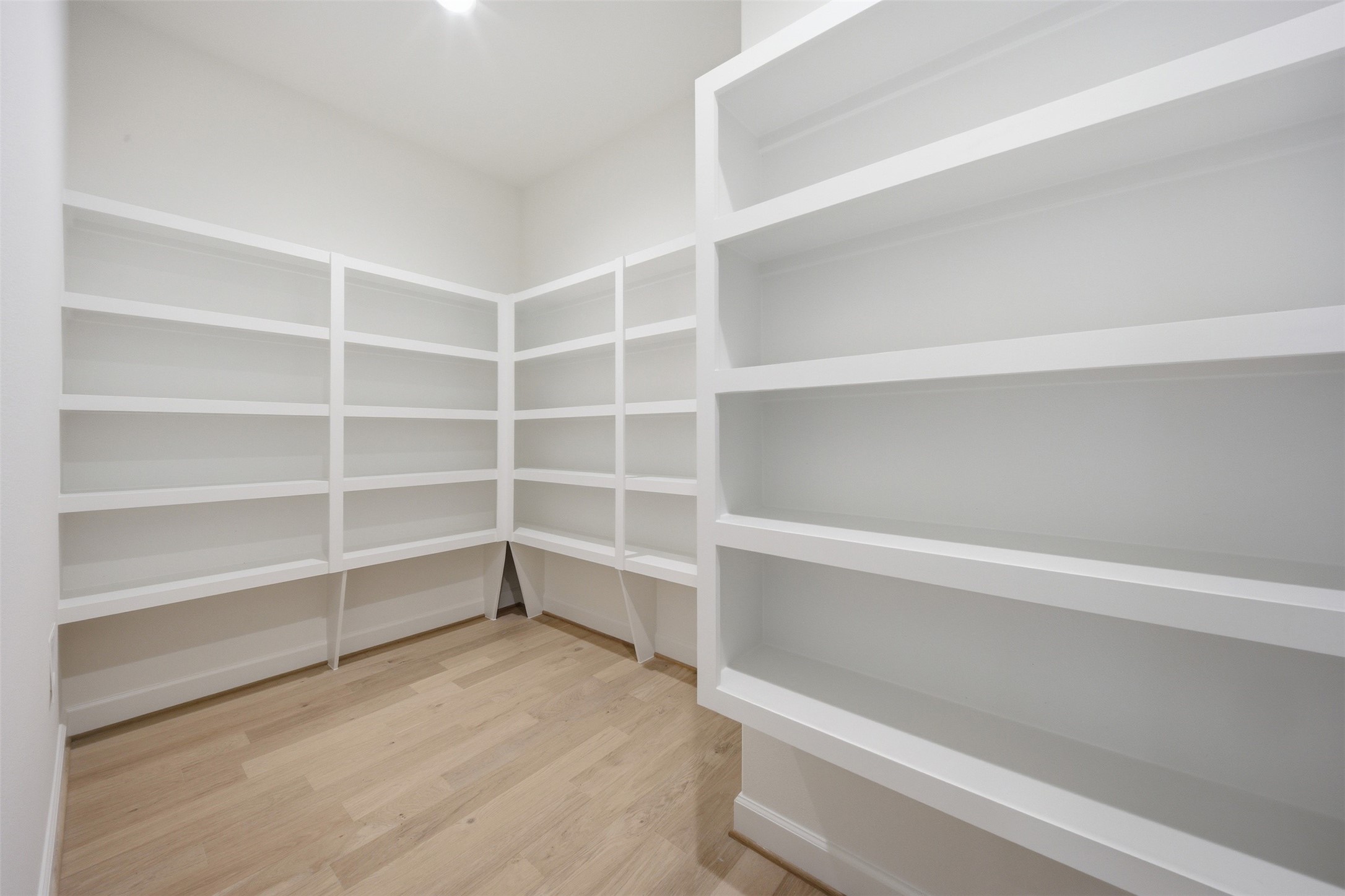 416 Venado View Court Conroe, TX 77304 - Photo 8 of 34 Large walk-in pantry with extensive built-in shelving providing exceptional storage and organization for everyday living and entertaining.