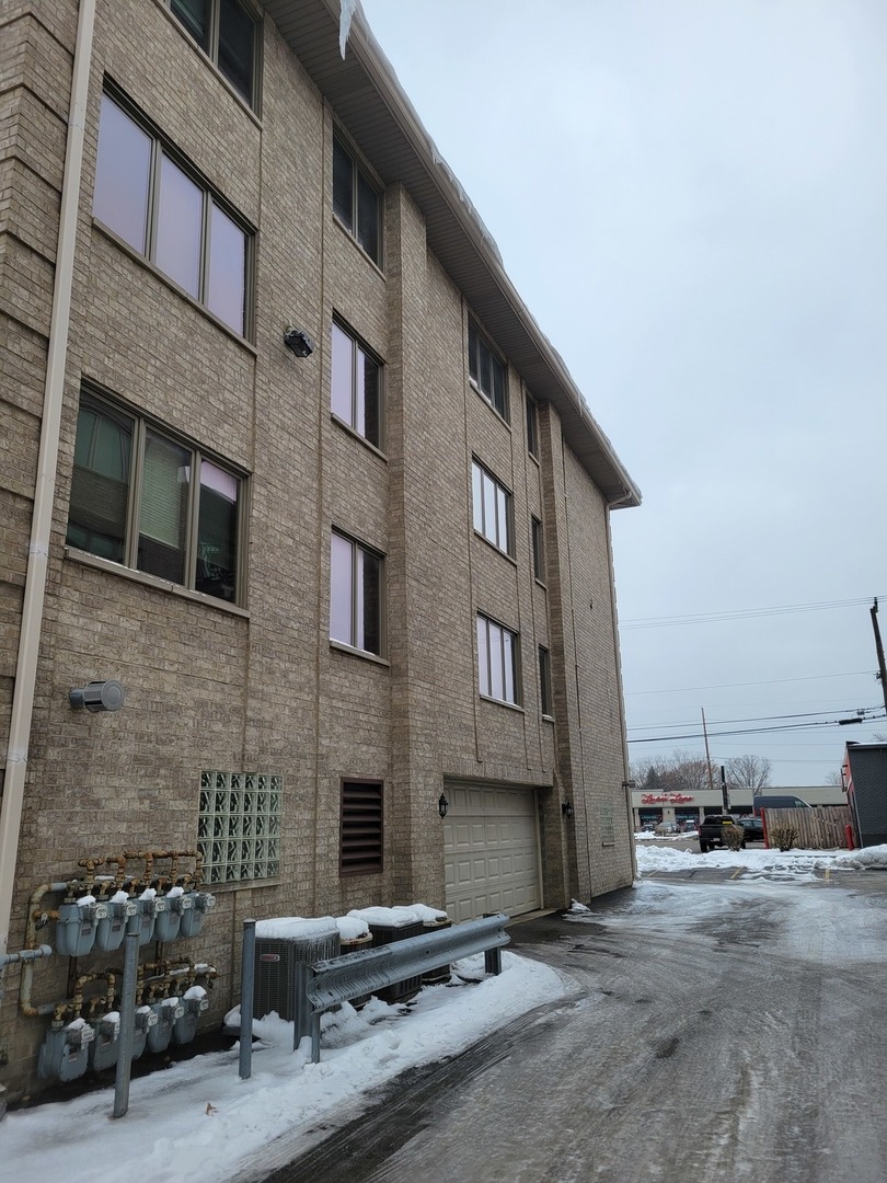 10418 South Keating Avenue, Unit 1A Oak Lawn, IL 60453 - Photo 15 of 15 a front view of a building with parking space