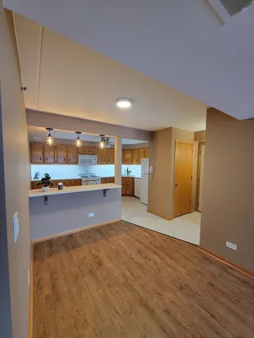 a view of kitchen with stainless steel appliances cabinets