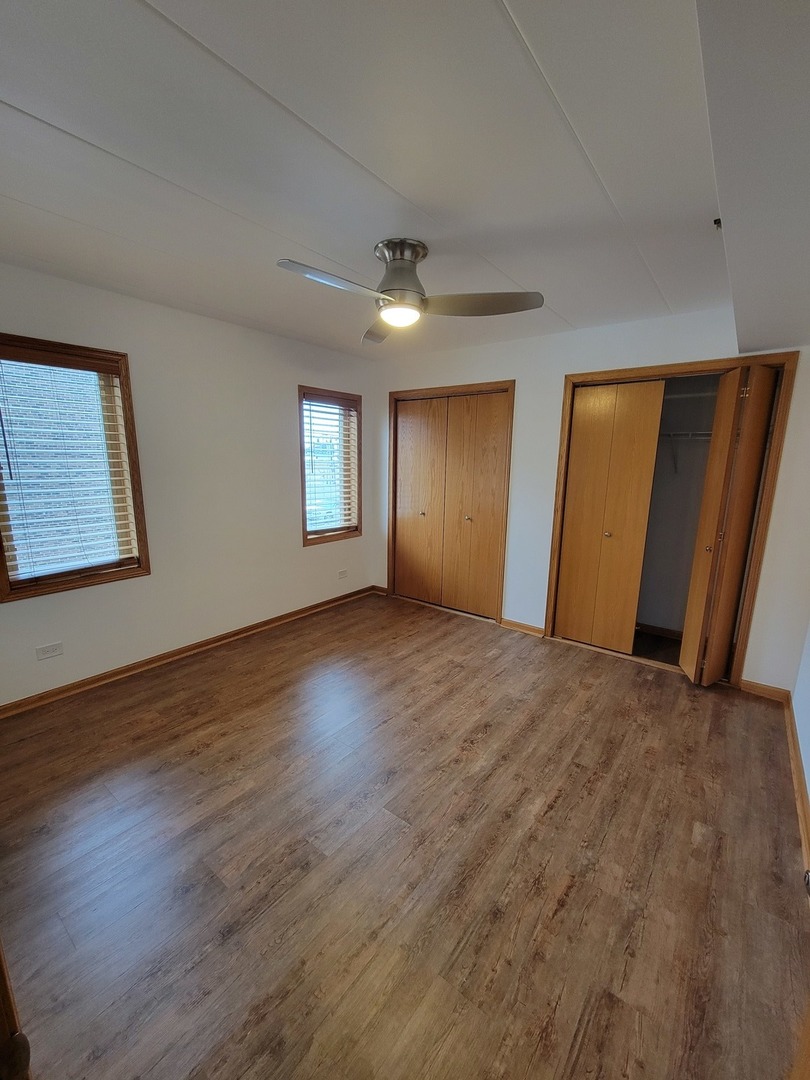 10418 South Keating Avenue, Unit 1A Oak Lawn, IL 60453 - Photo 10 of 15 a view of an empty room with wooden floor and a window