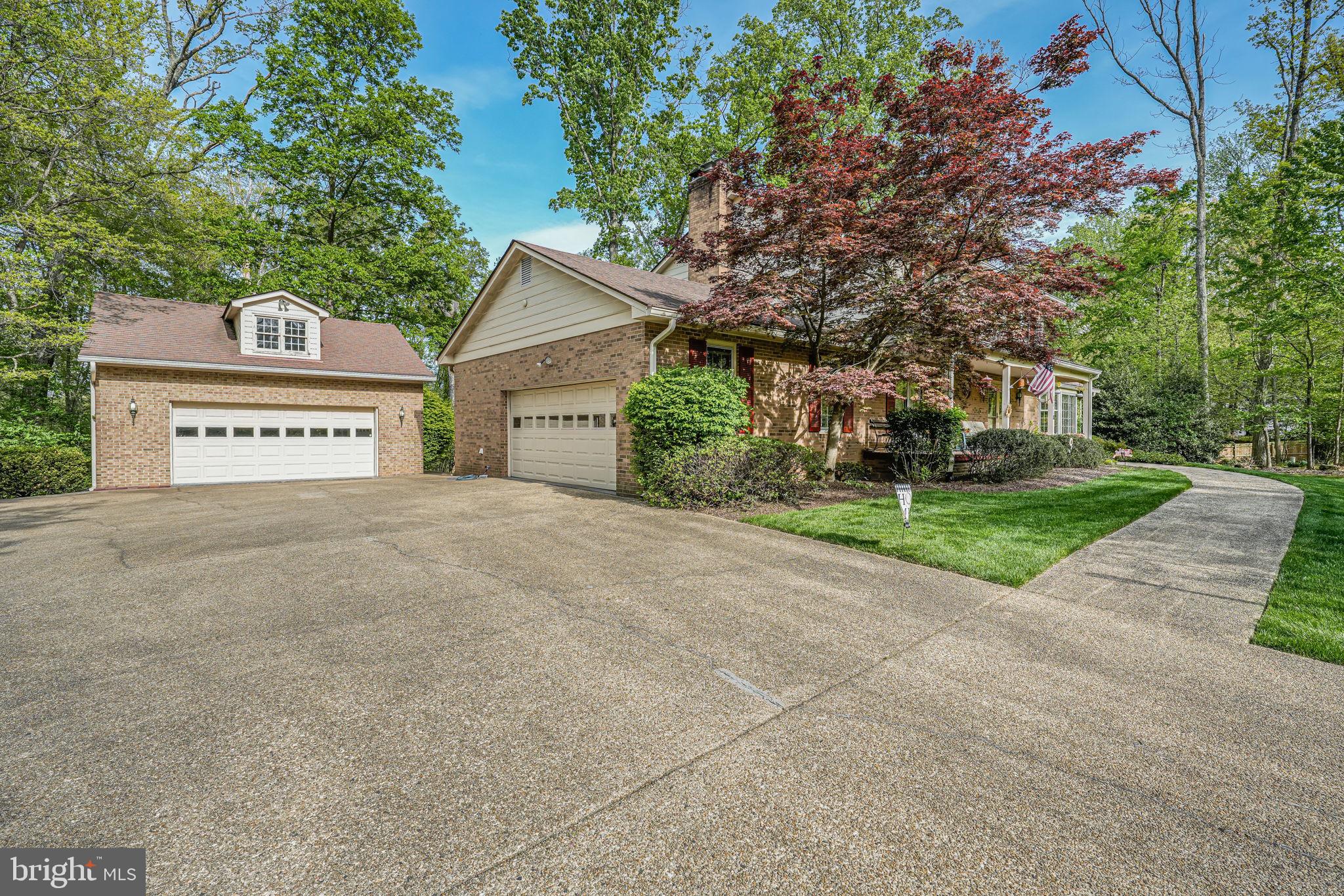 12003 Turf Lane Reston, VA 20191 - Photo 5 of 14 a view of a house with a yard and garage