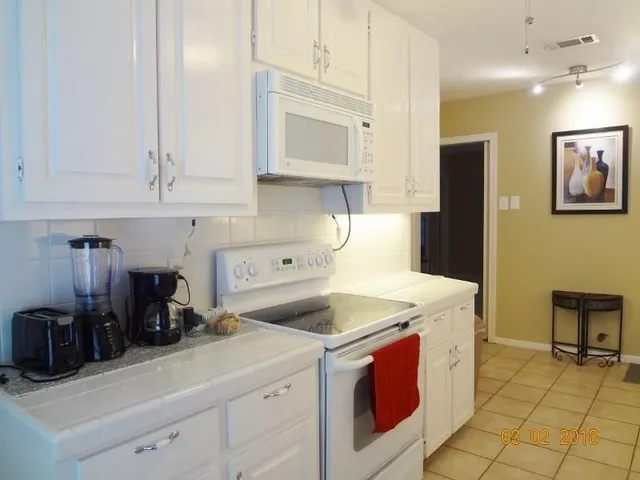 a kitchen with stainless steel appliances granite countertop a sink and cabinets