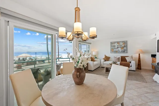 a living room with dining table furniture and a chandelier