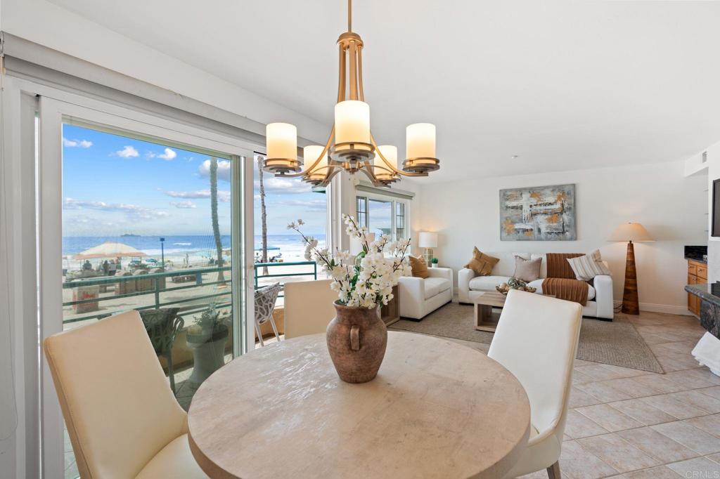 400 The Strand North, Unit 27 Oceanside, CA 92054 - Photo 11 of 25 a living room with dining table furniture and a chandelier