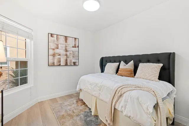 a large bed sitting in a bedroom next to a window