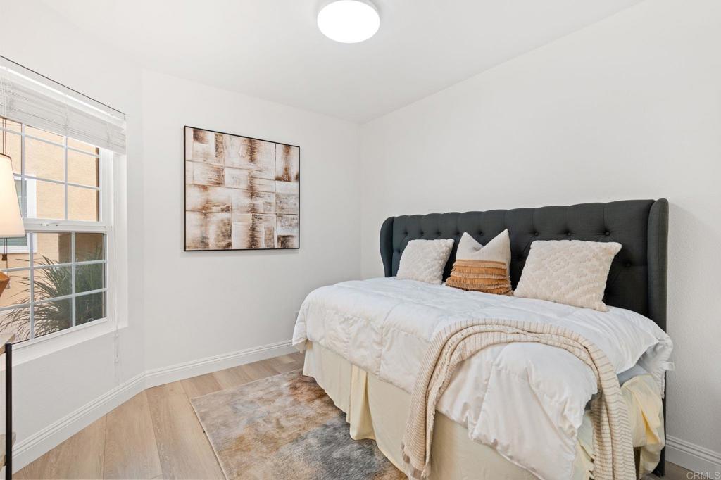 400 The Strand North, Unit 27 Oceanside, CA 92054 - Photo 13 of 25 a large bed sitting in a bedroom next to a window