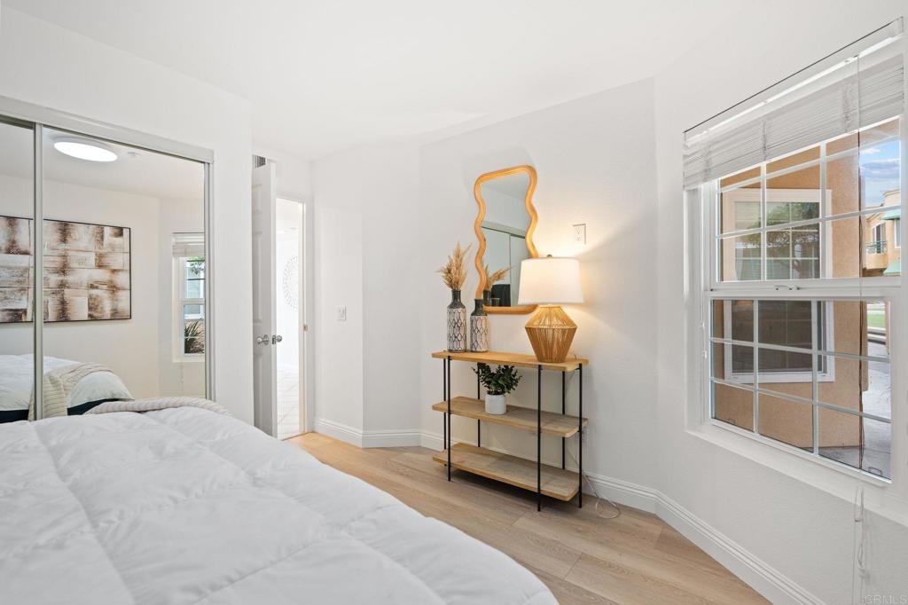 400 The Strand North, Unit 27 Oceanside, CA 92054 - Photo 14 of 25 a bedroom with a bed and a window