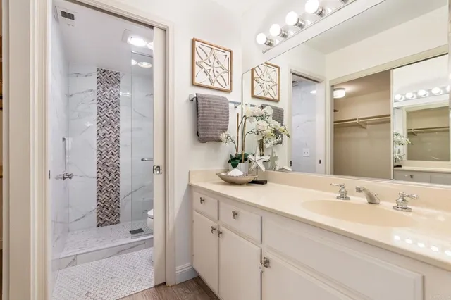 a bathroom with a tub sink and mirror