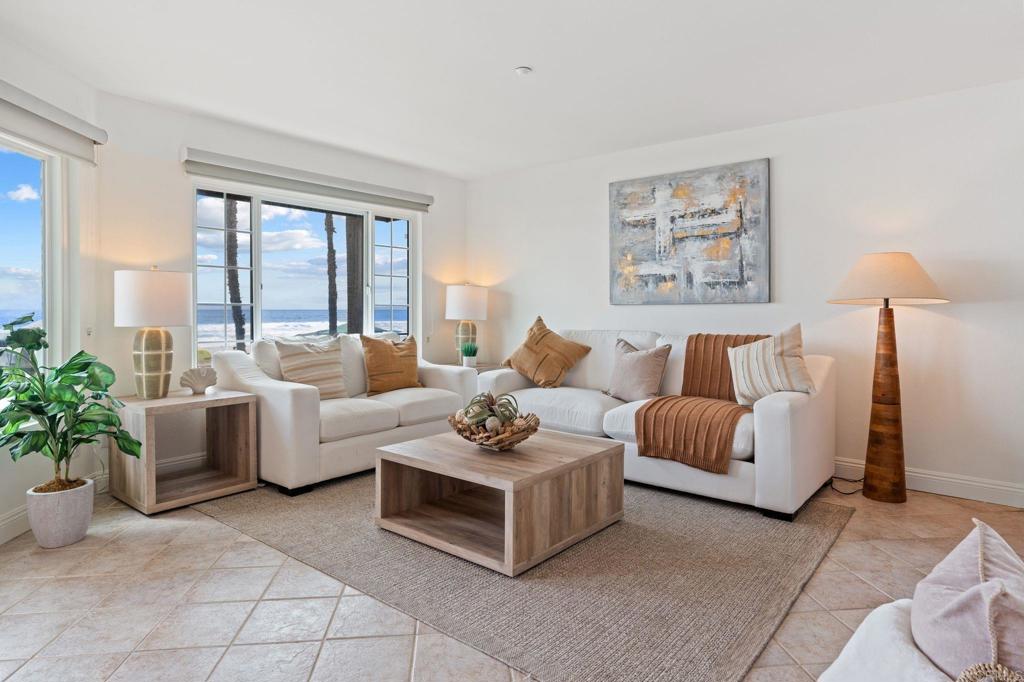 400 The Strand North, Unit 27 Oceanside, CA 92054 - Photo 6 of 25 a living room with furniture and a potted plant on table
