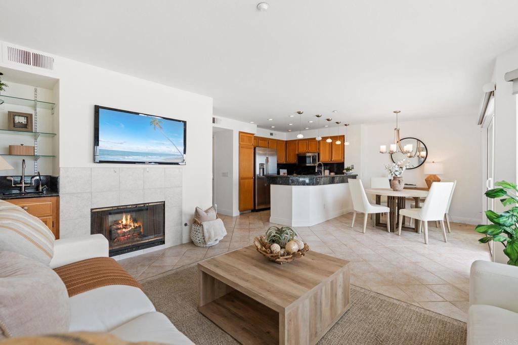 400 The Strand North, Unit 27 Oceanside, CA 92054 - Photo 8 of 25 a living room with furniture and a fireplace