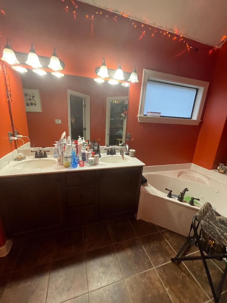 6885 Raleigh Lagrange Road Cordova, TN 38018 - Photo 3 of 6 a bathroom with a bathtub sink and mirror