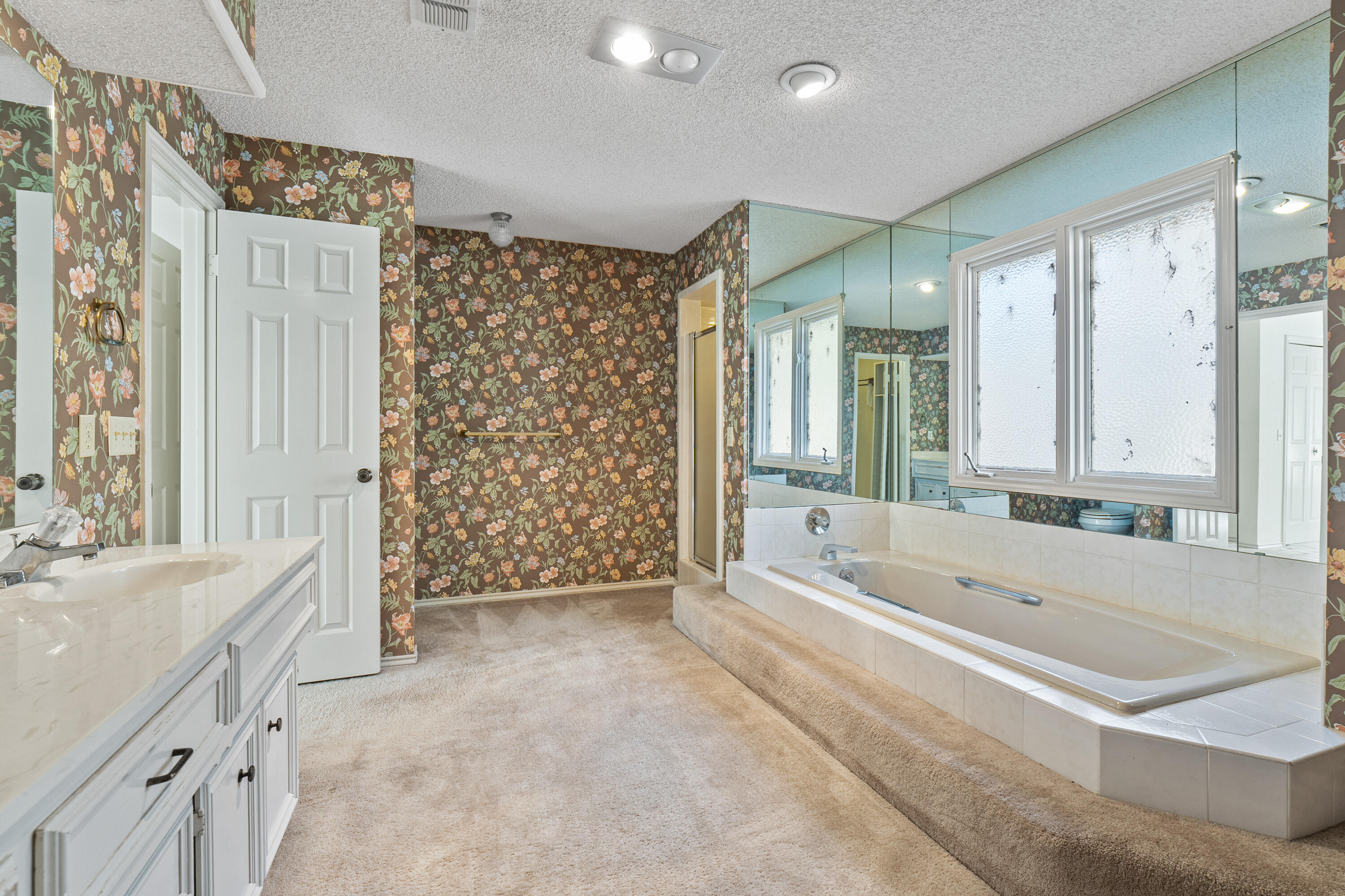 12 Foothill Drive Ransom Canyon, TX 79366 - Photo 33 of 36 a spacious bathroom with a double vanity sink mirror and a bathtub
