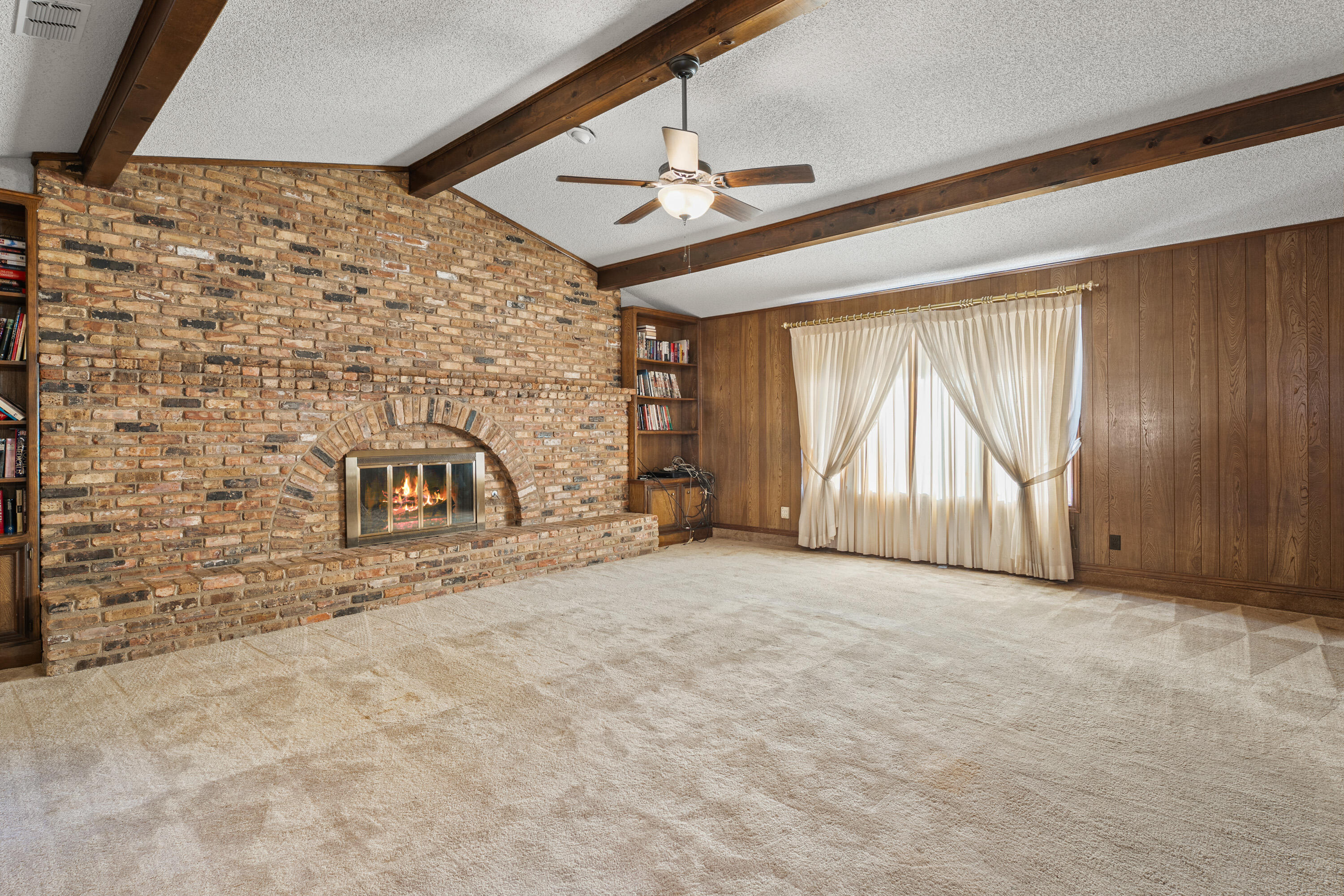 12 Foothill Drive Ransom Canyon, TX 79366 - Photo 4 of 36 a view of an empty room with a fireplace and a window