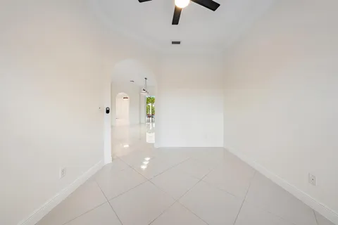 a spacious bedroom with a large bed and a chandelier