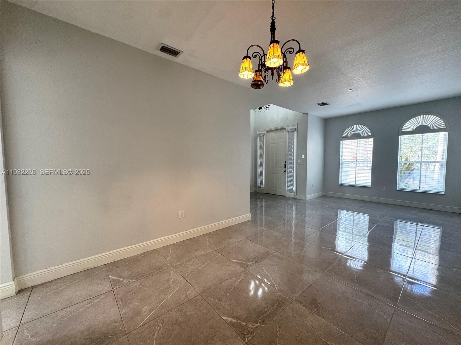 12283 Southwest 123rd Terrace Miami, FL 33186 - Photo 12 of 46 a view of a livingroom with a chandelier