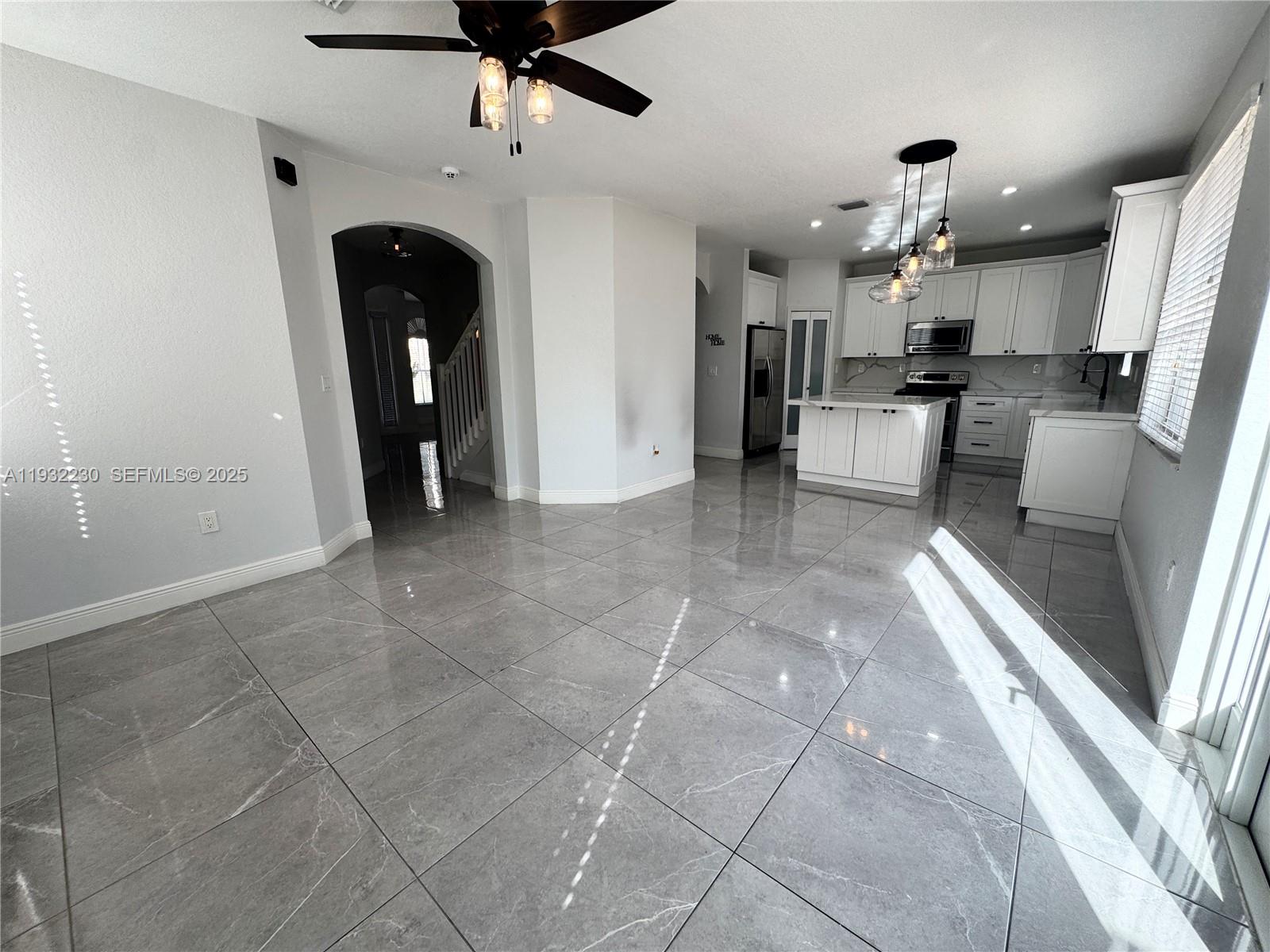 12283 Southwest 123rd Terrace Miami, FL 33186 - Photo 14 of 46 a view of a living room and kitchen with granite countertop a sink