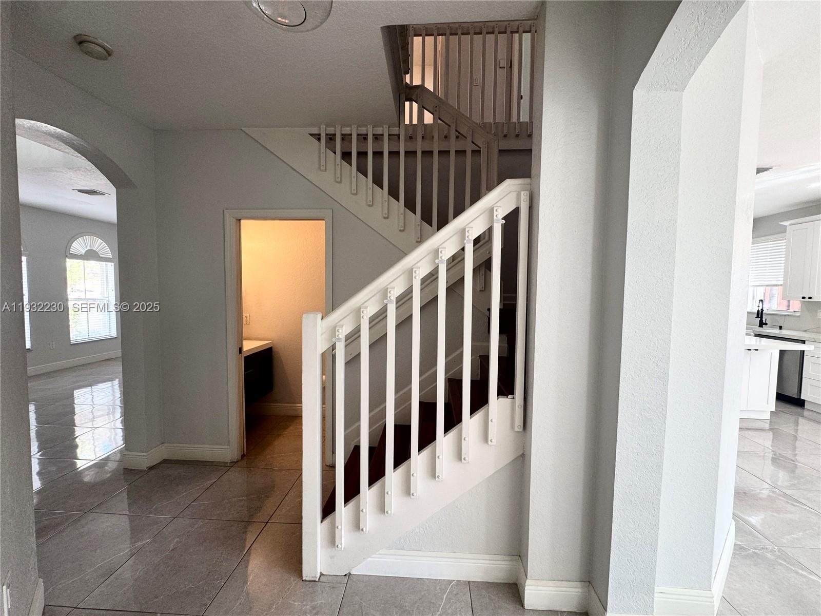 12283 Southwest 123rd Terrace Miami, FL 33186 - Photo 17 of 46 a view of staircase with railing and a chandelier