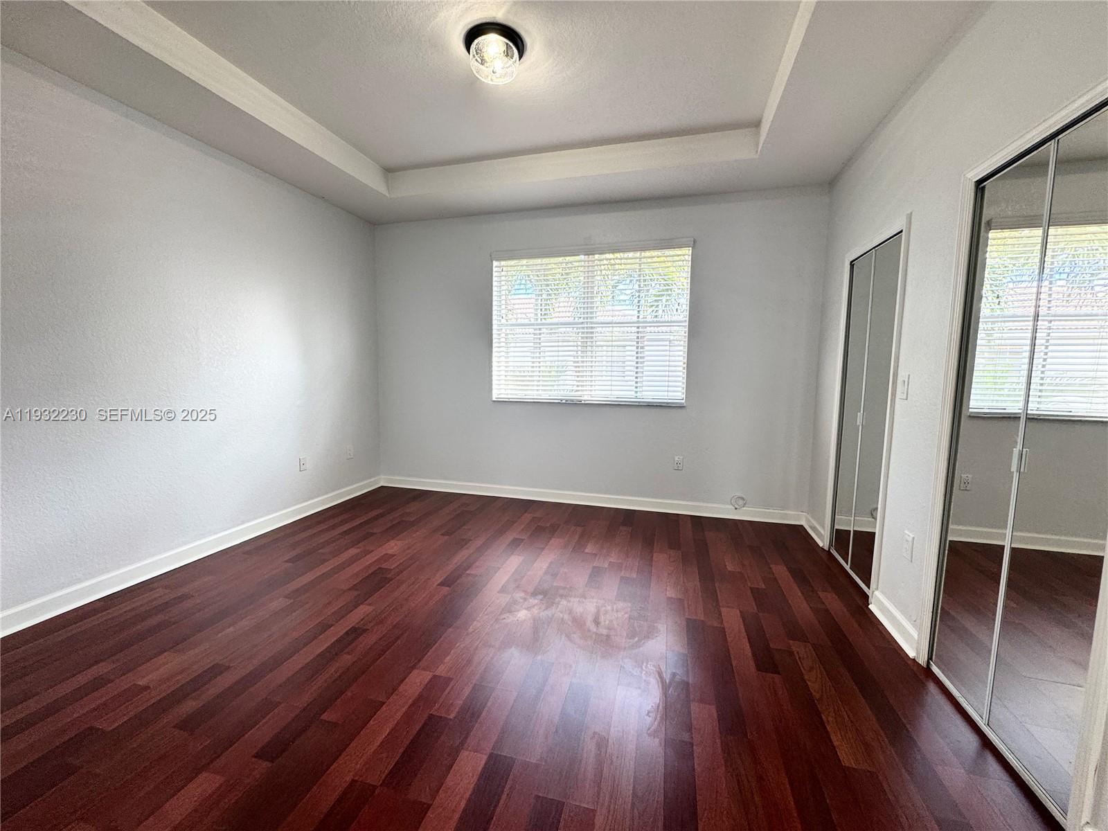 12283 Southwest 123rd Terrace Miami, FL 33186 - Photo 20 of 46 an empty room with wooden floor and windows
