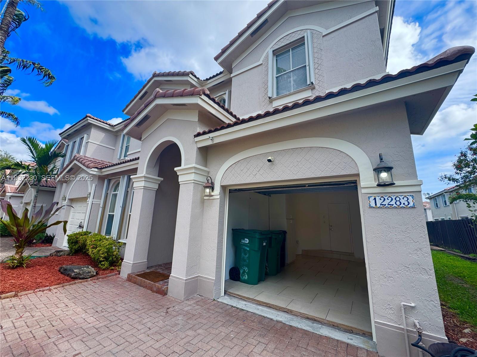 12283 Southwest 123rd Terrace Miami, FL 33186 - Photo 2 of 46 a front view of a house with entryway