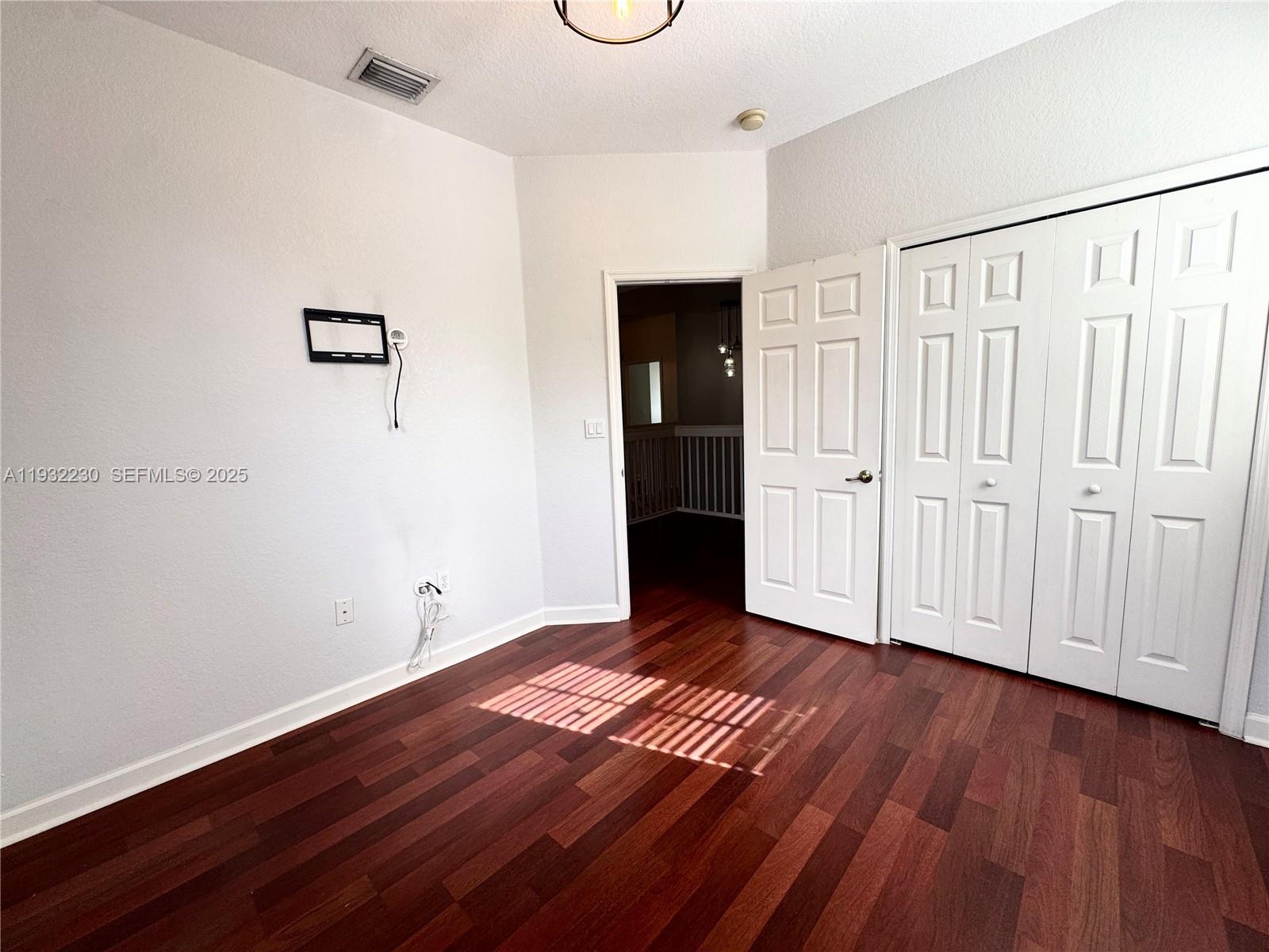 12283 Southwest 123rd Terrace Miami, FL 33186 - Photo 23 of 46 a view of an empty room with wooden floor