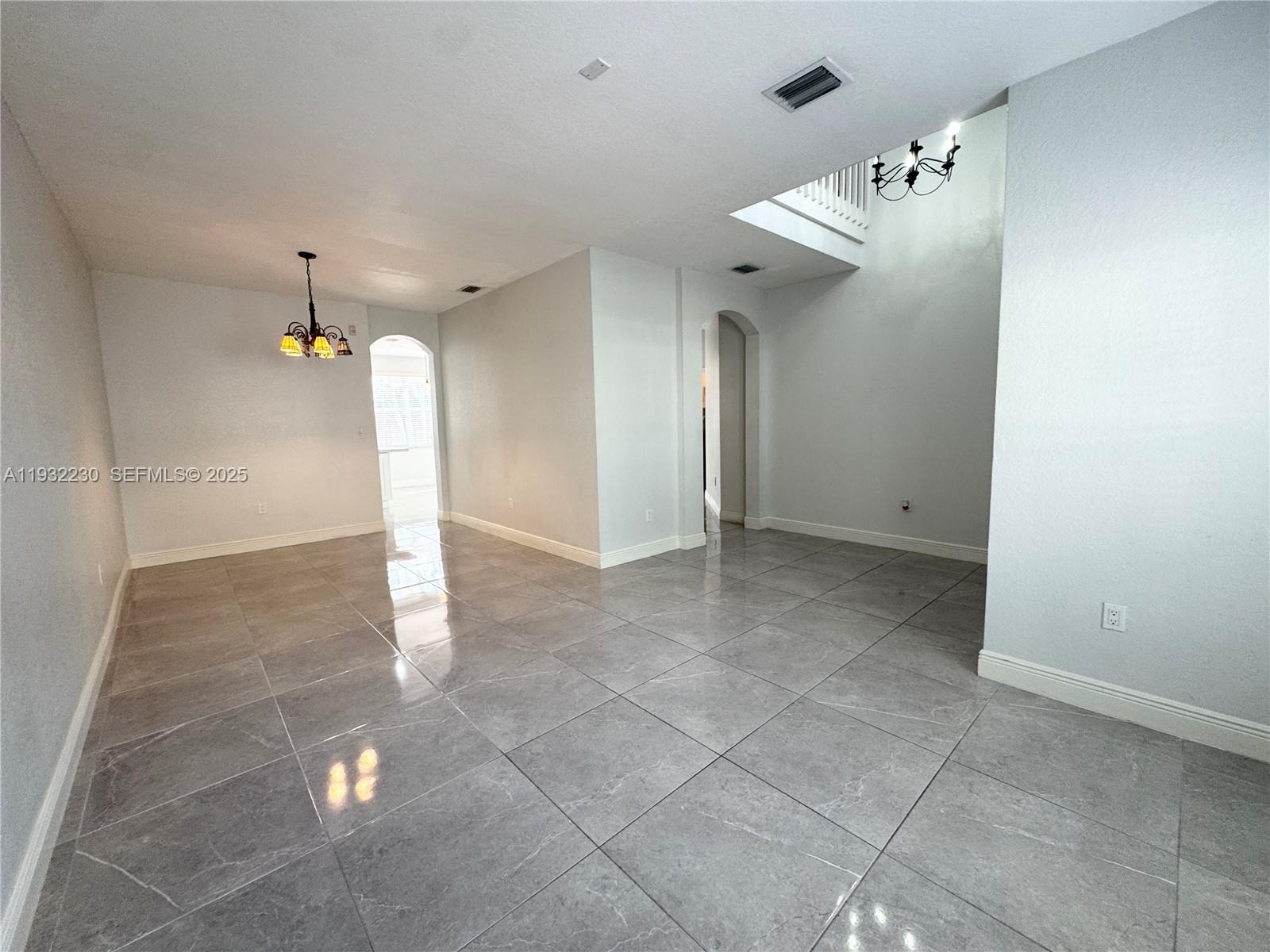 12283 Southwest 123rd Terrace Miami, FL 33186 - Photo 28 of 46 a view of a hallway with chandelier