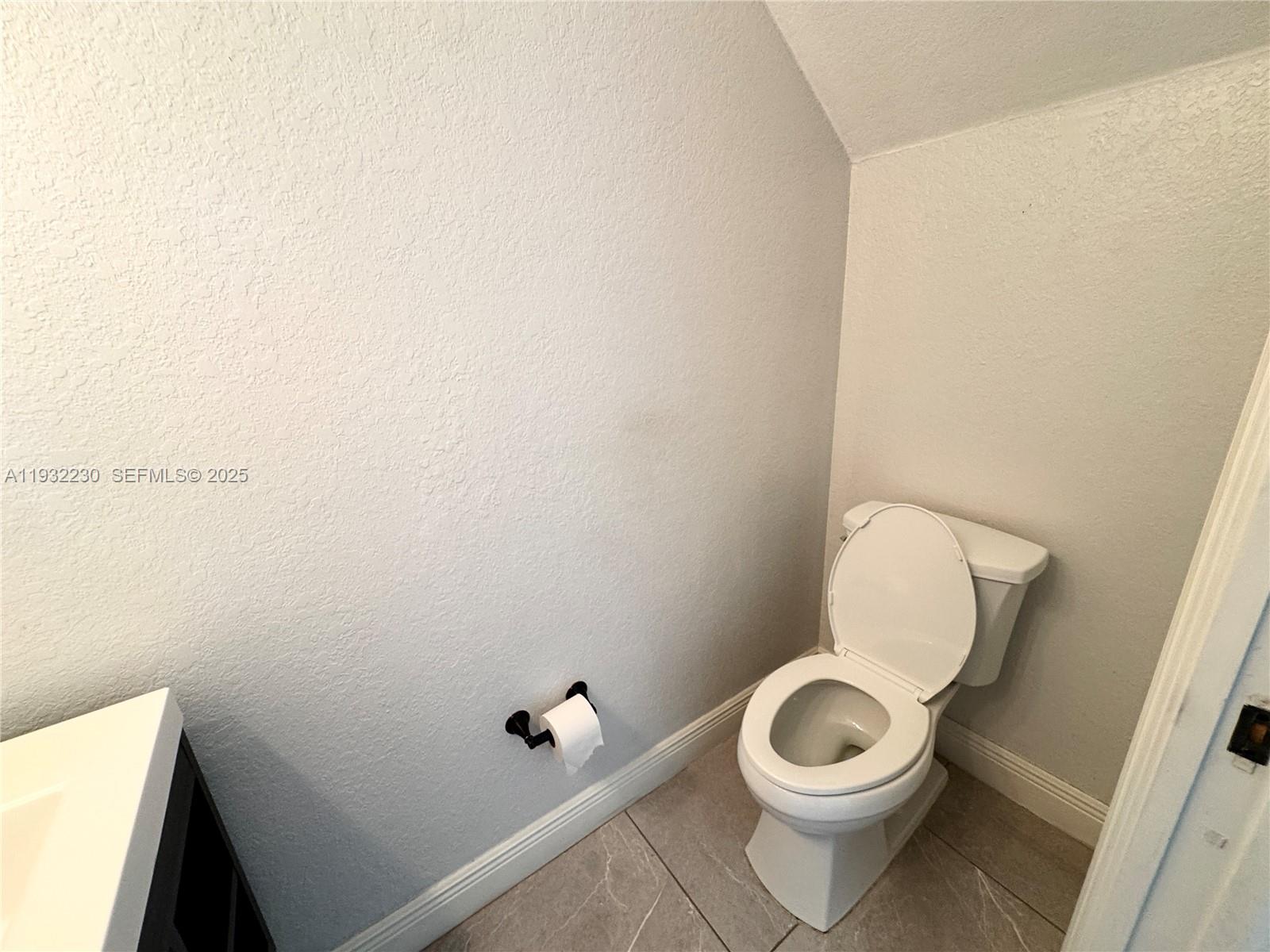 12283 Southwest 123rd Terrace Miami, FL 33186 - Photo 35 of 46 a white toilet sitting next to a white sink and vanity