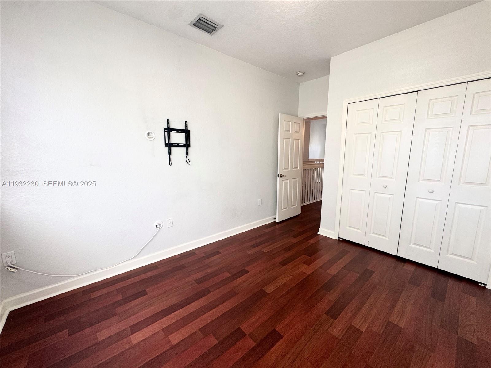 12283 Southwest 123rd Terrace Miami, FL 33186 - Photo 38 of 46 an empty room with wooden floor