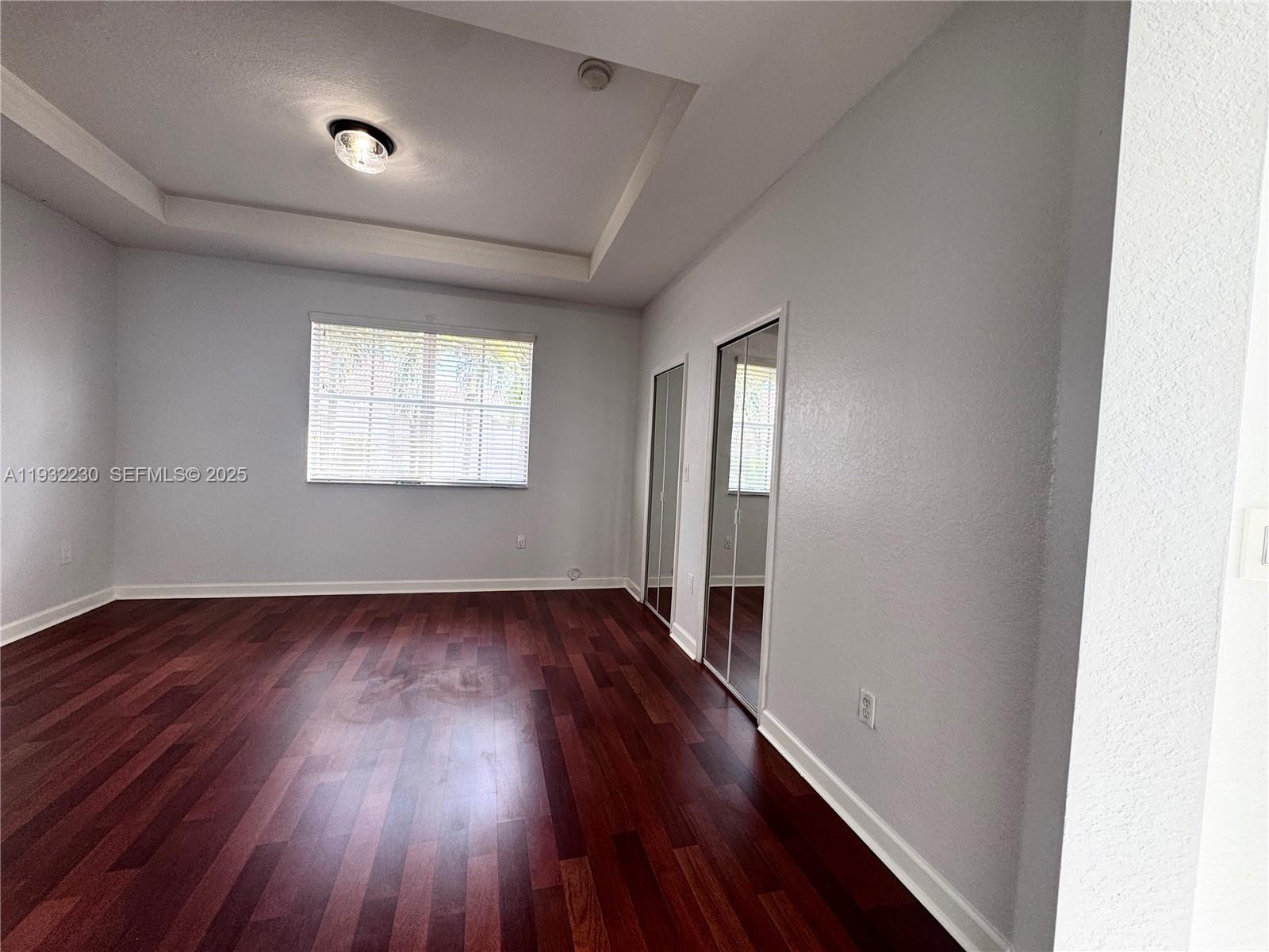 12283 Southwest 123rd Terrace Miami, FL 33186 - Photo 39 of 46 an empty room with wooden floor and windows